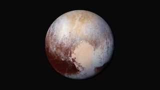Pluto with patches of rusty brown and sandy yellow on the surface.